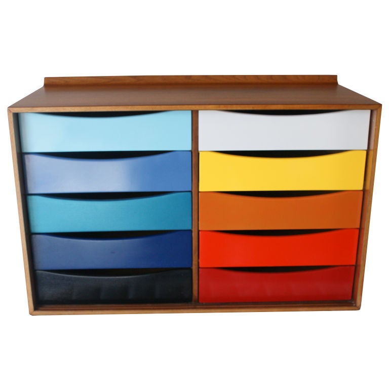 A mid century modern cabinet designed by Finn Juhl and made by Baker.  Walnut case with ten multi-colored drawers.