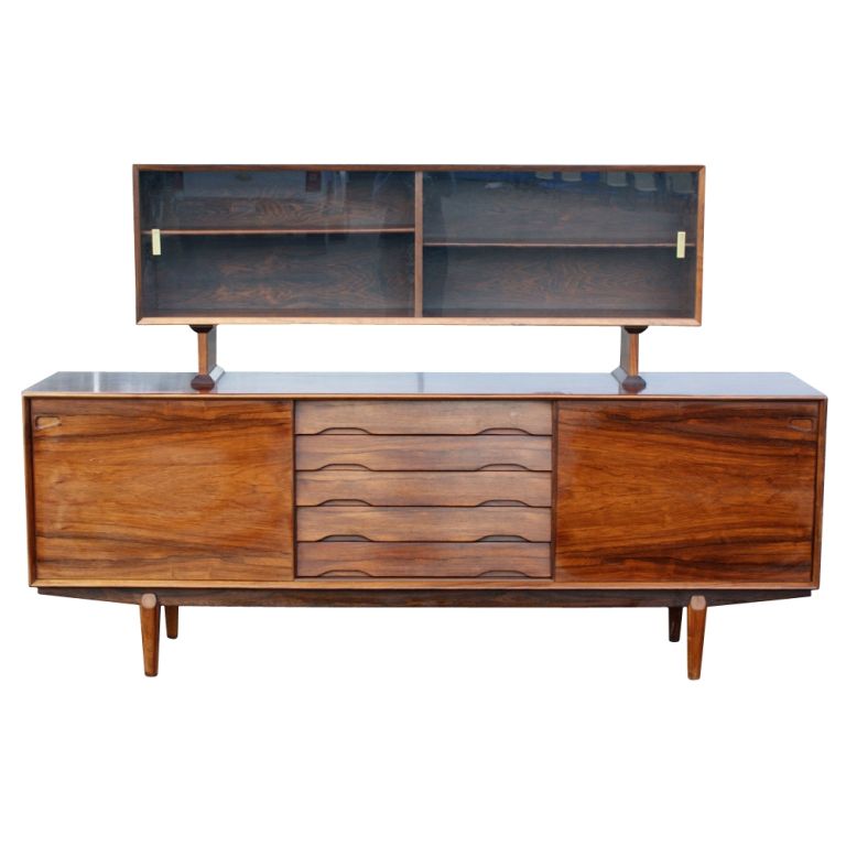 A mid century modern rosewood buffet and china cabinet made in Denmark by Skovby.  The lower buffet measuring 86.5