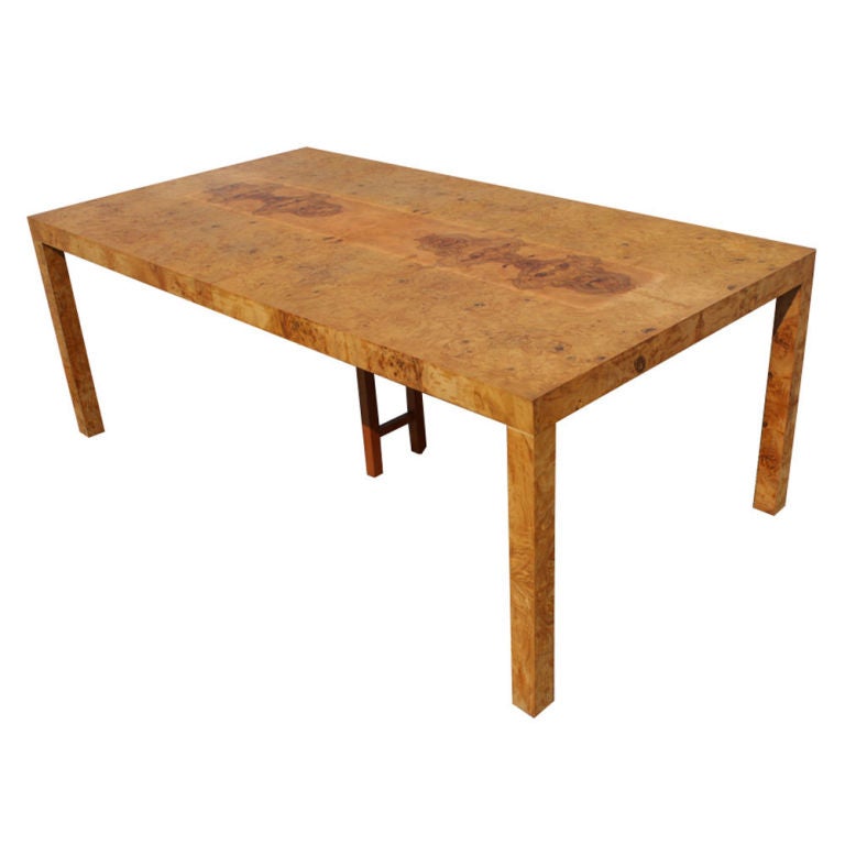 A mid century modern extension dining table designed by Milo Baughman and made by Thayer Coggin.  The table of burled olivewood with two 21