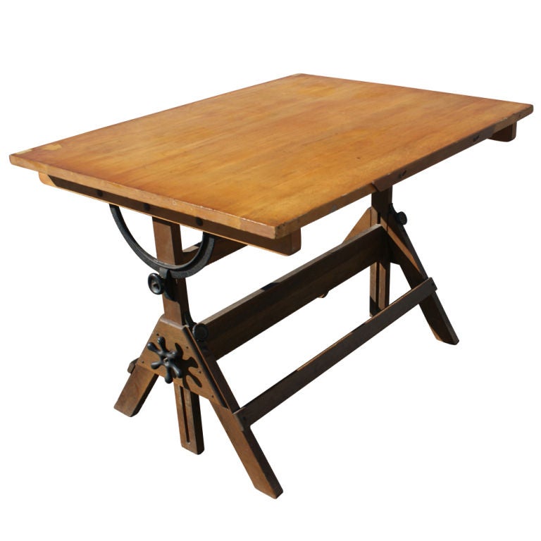 A drafting table c.1930's made by Hamilton with an oak base and maple top.  Nicely patinated iron hardware allows for height adjustment from 33
