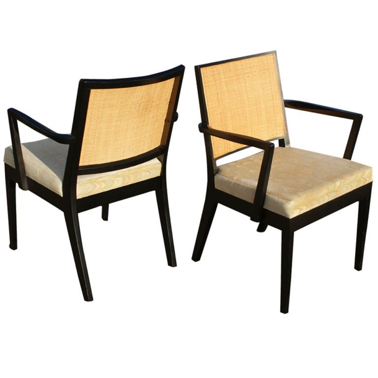 A set of six mid century modern dining or side chairs by Stewart MacDougall for  Glenn of California.  Ebonized wood frames with woven cane backs and upholstered seats.  Two armchairs and four side chairs.