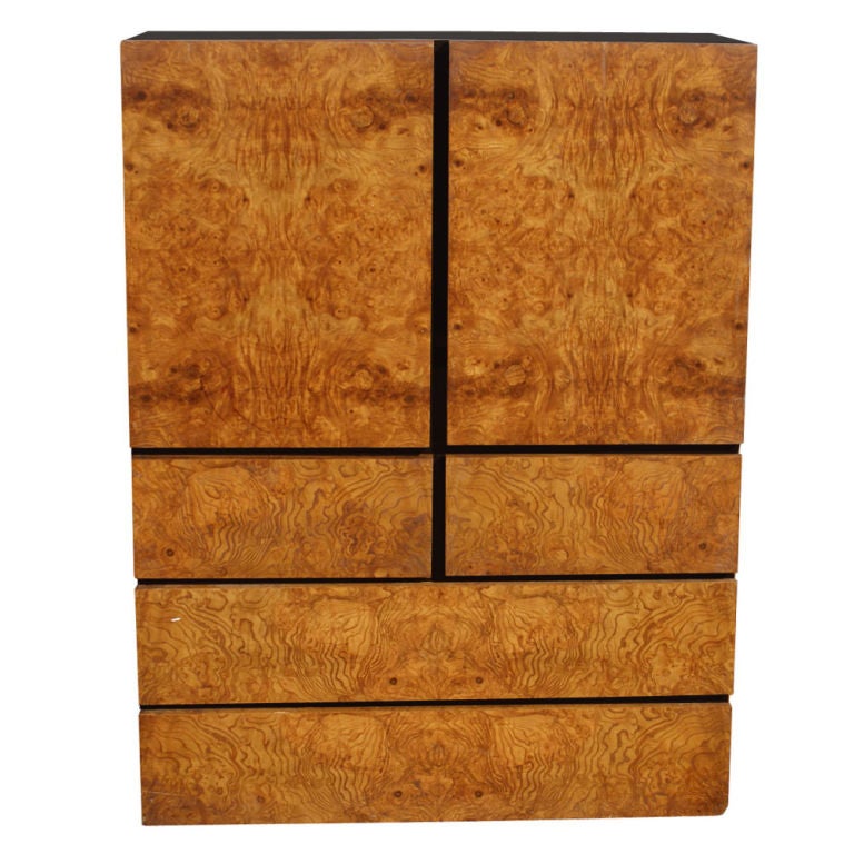 A mid century modern armoire made by Lane in an attractive burled wood.  Double doors concealing a large drawer and partitioned storage.  Two large and two smaller drawers below.  If the partitions are removed, the cabinet could be used as an