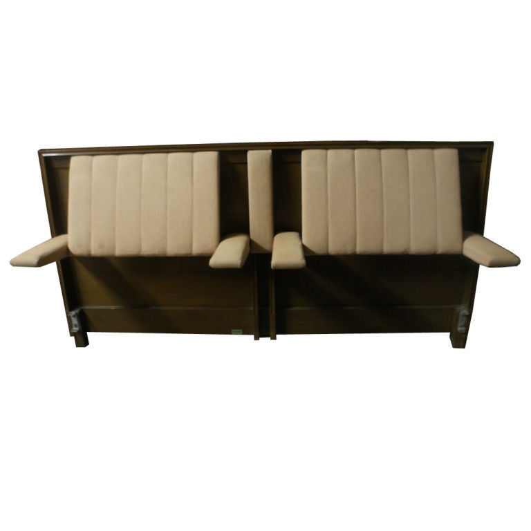 A mid century modern headboard for a king-size bed designed by Edward Wormley and made by Dunbar.  Pull down arms with back rests that pop out at an angle for sitting in bed.  Mahogany with cream colored fabric upholstery.