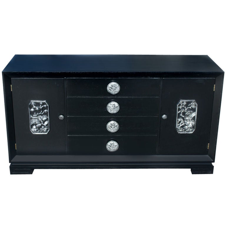 Chin Hua inspired buffet or cabinet designed by James Mont.  Ebonized oak with silver leaf detailing.  Four center drawers with carved pulls and two side doors with shelved storage.