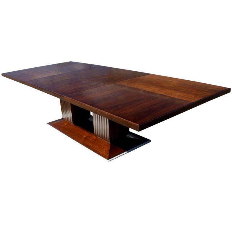 A large dining or conference table made by Bolier & Company and part of their Atelier Collection.  Two-tone walnut top with fluted double pedestal supports on a beveled base.  Two 20