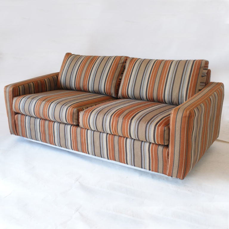 A mid century modern loveseat or sofa designed by Milo Baughman and made by Thayer Coggin.  Original striped upholstery on a chrome plinth base.