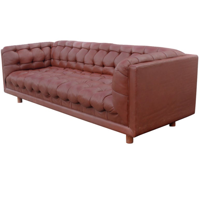 A mid century modern Chesterfield style sofa designed by Ward Bennett and made by Brickel Associates upholstered in reddish brown leather.