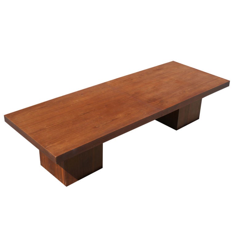 A mid century modern expandable coffee table designed by John Keal for Brown Saltman in 1964.  The table can also be used as a dining table with the guests seated on the floor.  Walnut with a black laminate center section.  The table extends form