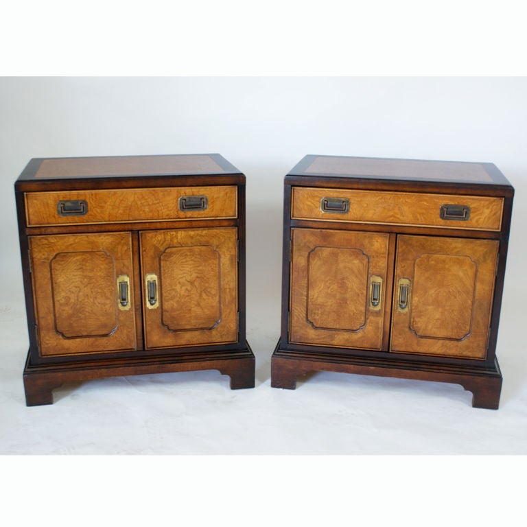 A pair of nightstands made by Century featuring Asian styling.  Burled and ebonized wood with brass hardware.  We have several other pieces of Century bedroom furniture on 1stdibs.