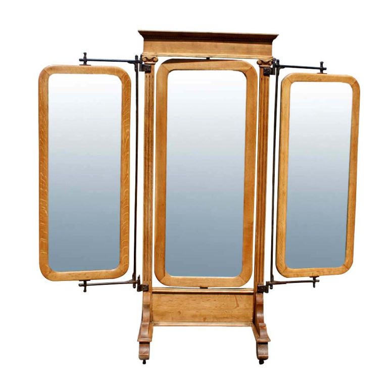 An American Empire triple floor mirror.  Three movable, rotating mirrors on iron arms mounted on an oak stand.  The stand with Ionic column detailing and casters.  A very functional as well an aesthetically appealing piece.