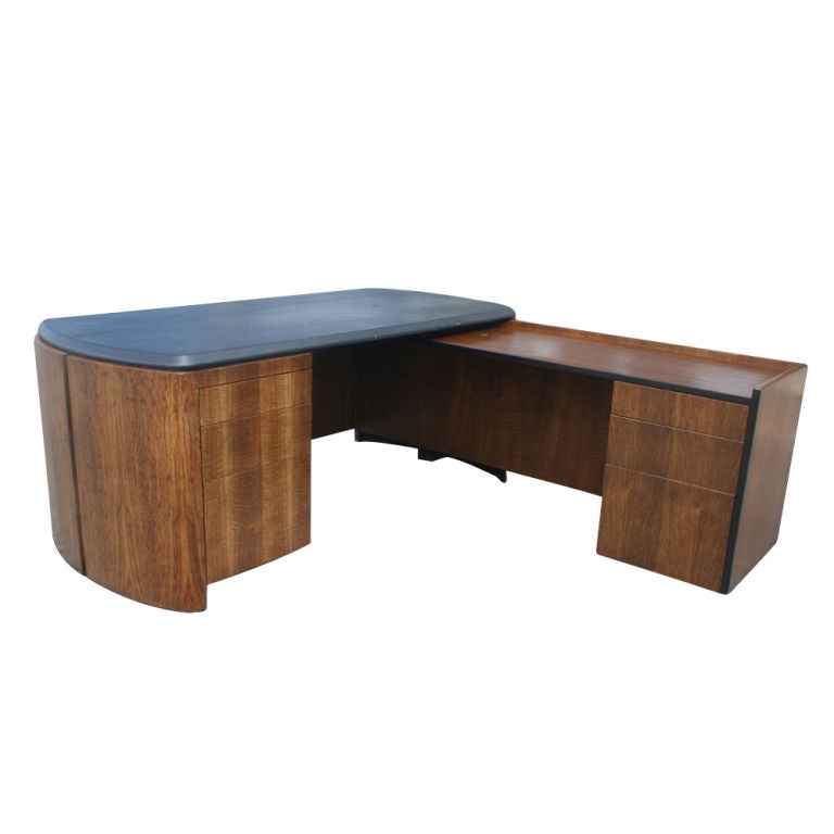 Lydia dePolo and Jack Dunbar started the firm of DePolo Dunbar back in the 1970s after working together at  Skidmore, Owings and Merrill.  

Vintage bookmatched quartersawn oak veneer executive desk with right return designed by Lydia DePolo for