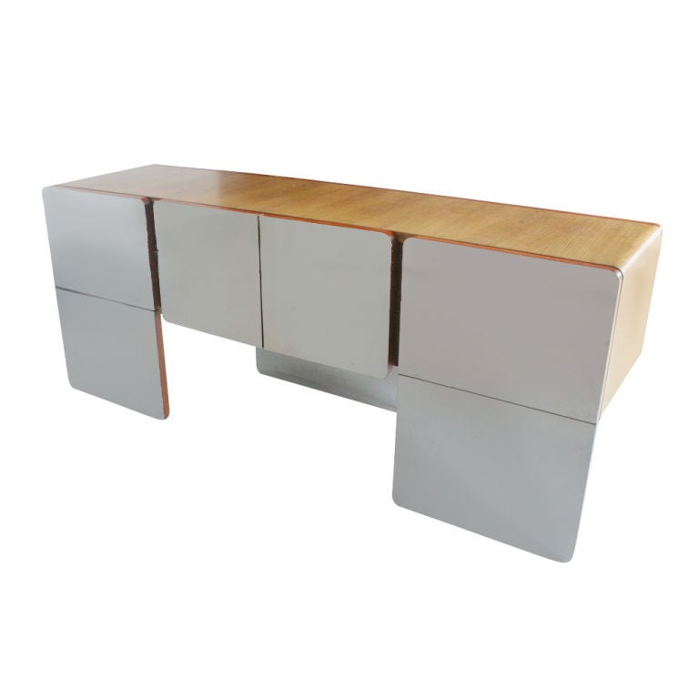 A mid century modern credenza made by Xception with an oak case and mirrored facings.  Two large file drawers and double doors with shelved storage.  As shown in the last image, a matching desk is available.