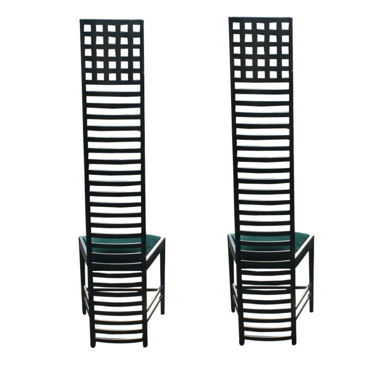 A pair vintage Hill House chairs designed by Charles Rennie Mackintosh and made by Cassina, the licensed maker of Mackintosh furniture.  Black lacquered ash frame with original green velvet upholstery.