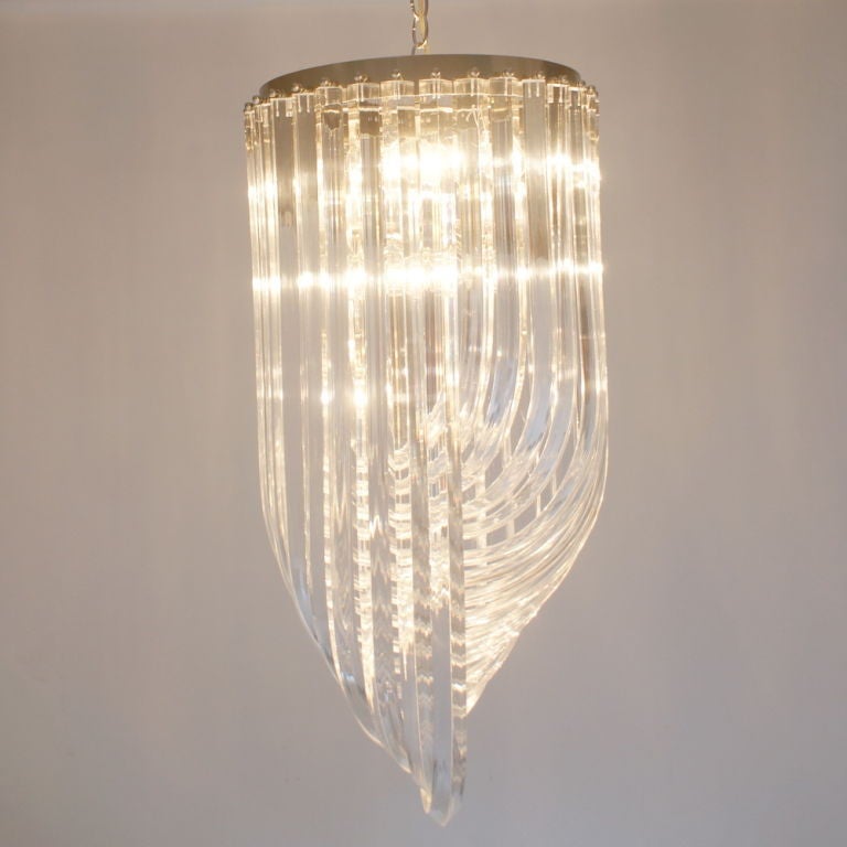 A stunning mid century modern chandelier composed of bent acrylic rods with fifteen bulbs.