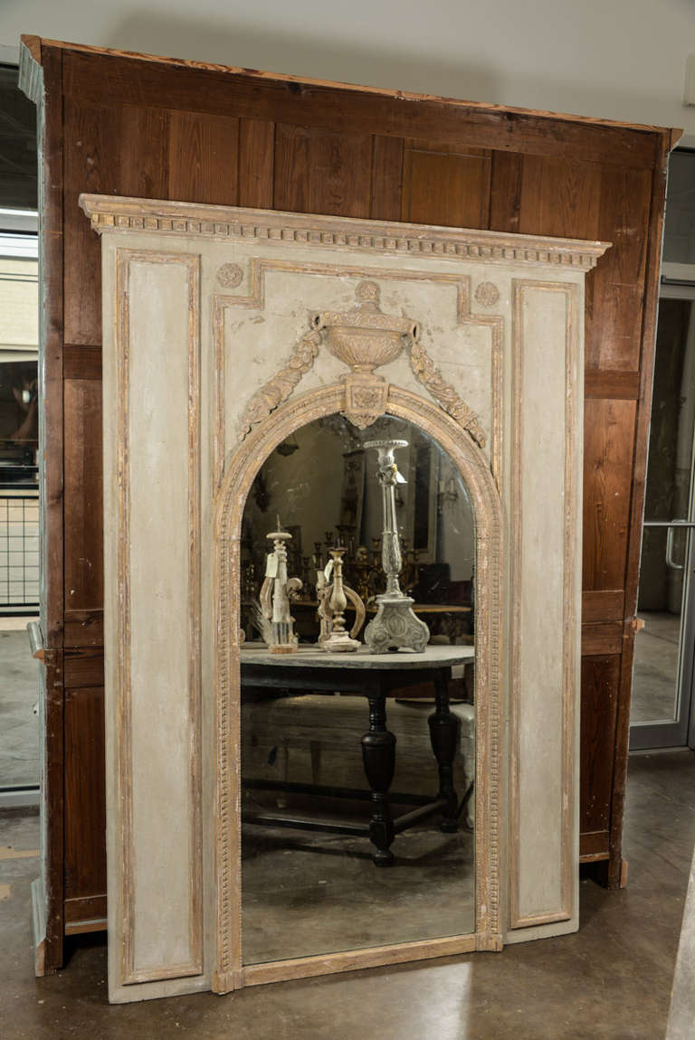 This fabulous Louis XVI Trumeau mirror is like looking thru a doorway into 19th Century French Aristocracy! Admire the hand carved and gilded columns, moldings, trim work and 3 dimensional motifs, on a celadon (blue/green) background. The unique