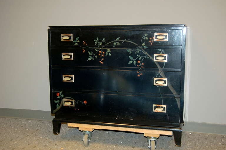 Stylish chest for Johnson Brothers, circa 1950s, attributed to Renzo Ritili. Black lacquered base with floral painted detail. Stylized brass pulls and signature legs. 

The chest stands 32 inches high. It is 38 inches wide and 20 inches deep.