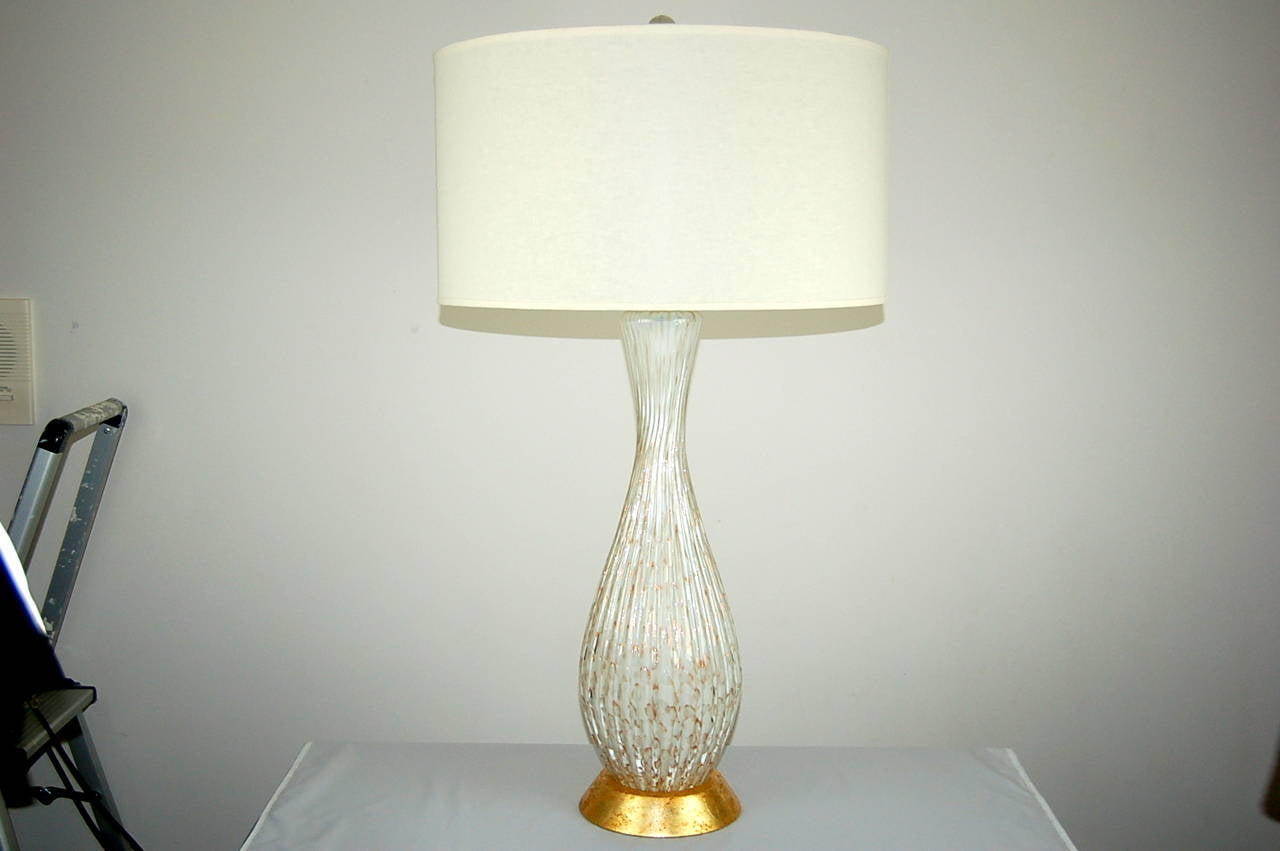 An imposing pair of vintage Murano table lamps of CREAMY VANILLA, with loads of controlled bubbles. The bubbles are ringed with copper, with lots of melted COPPER BITS and flakes peppered throughout the glass. 

They stand 31 inches from tabletop to