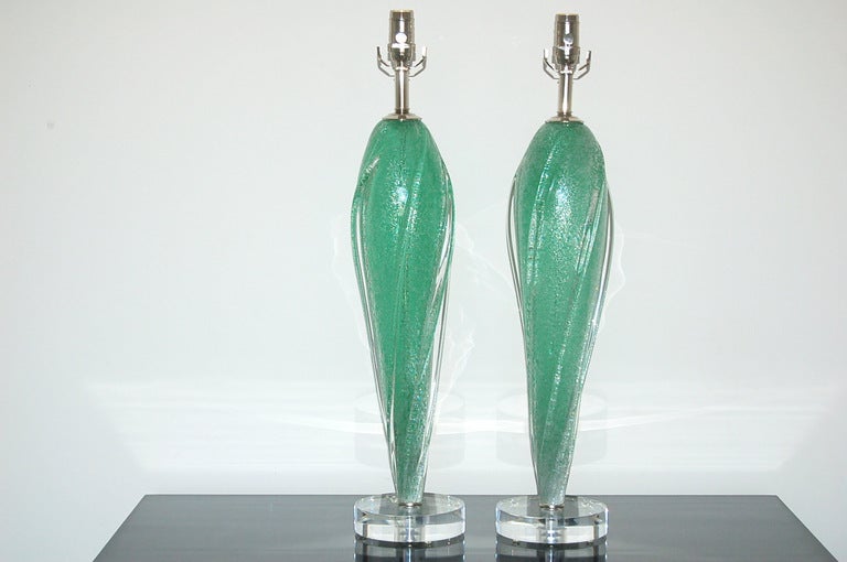 Stylish pair of SEA FOAM GREEN Murano lamps by Archimede Seguso.  Fins are of applied glass, the thousands of trapped air bubbles give the lamps depth and texture.

Each lamp measures 28 inches from tabletop to socket top.  As shown, the top of