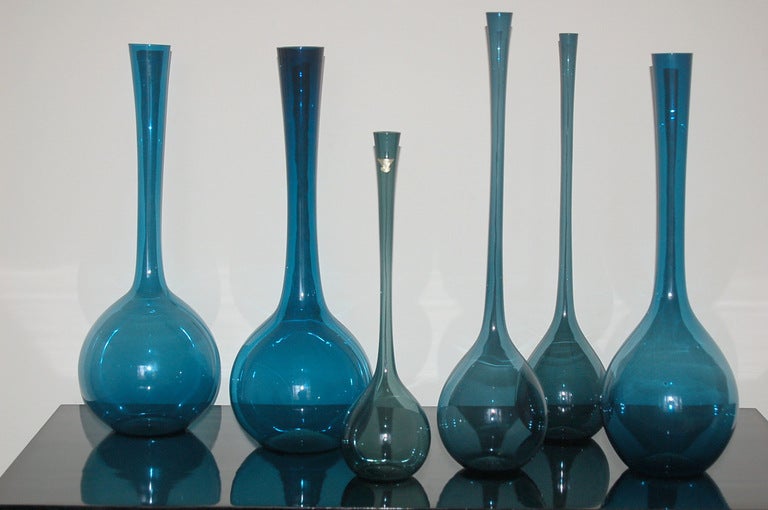 A matching set of six MOODY BLUE bottle vases designed by artist Arthur Percy for Gullaskruf Glass, 1951. Hand blown Swedish glass of TEAL BLUE - a very elegant, special collection!

Two vases have the Gullaskruf foil label. Tallest vase is 21