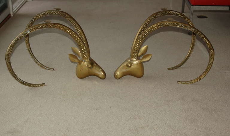 A lovely patinated pair of vintage Ram's Head/Ibex Head bases, coffee table sized.  This is the animal friendly design, where these guys are resting on their necks, rather than their foreheads. 

All four suction cups are present at top, ready to