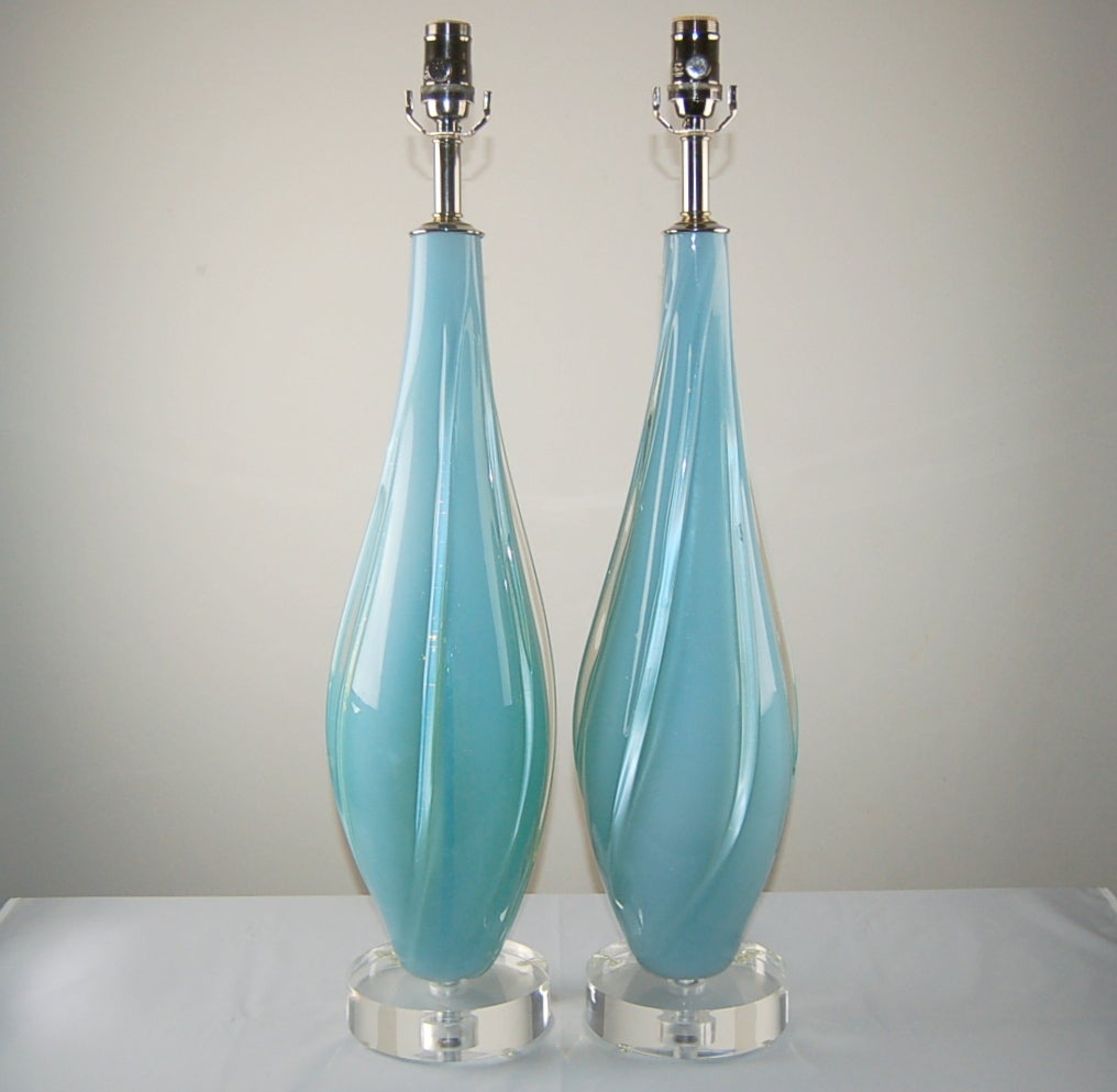 Magical SKY BLUE, with an intensity and depth courtesy of the opaline. In addition are clear applied glass vertical swirling ribs. A perfectly matched pair. 

The lamps are 29 inches from tabletop to socket top. As shown, the top of shade is 34