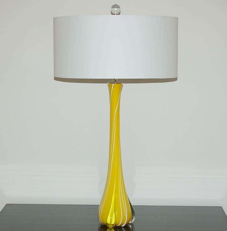 Breathtaking sunshine yellow with white drizzled glass along the body, like icing. The three legs are of clear glass. Rarely, rarely does one find this intense a yellow in Murano glass!

The lamps stand 28 inches from tabletop to socket top. As