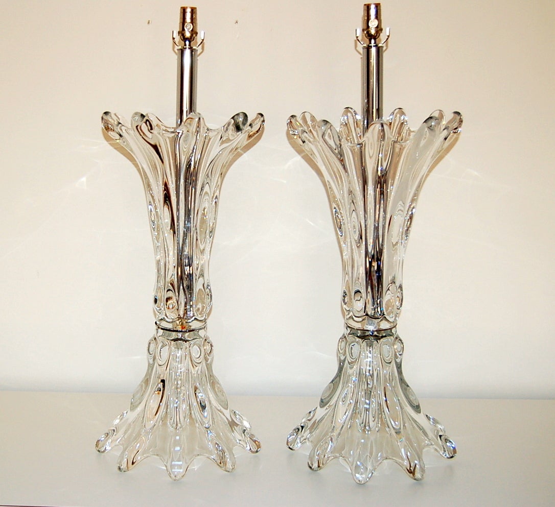 Breathtaking vintage crystal lamps from Vannes, France. Each lamp is made of two enormous glass pieces, separated by a thin nickel wafer. Such sculptural style!

The two glass pieces measure 27 inches in height, and 12 inches in width. The lamp is