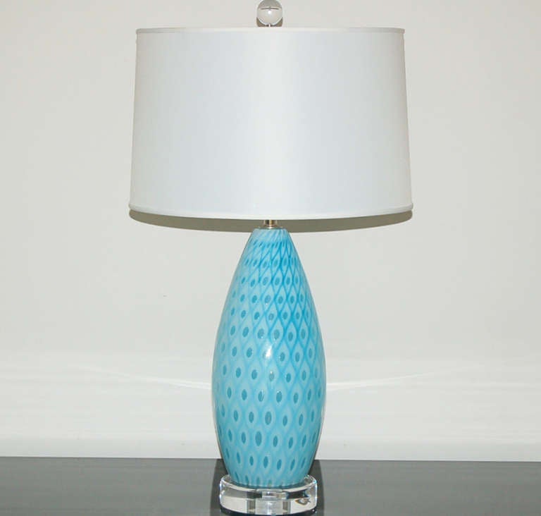 Blown by Galliano Ferro in the 1950's, these beautiful MALIBU BLUE lamps are in Ferro's trademark peacock feather design. As the technique used to create this effect was so difficult and never copied by other glass artisans, they are extremely