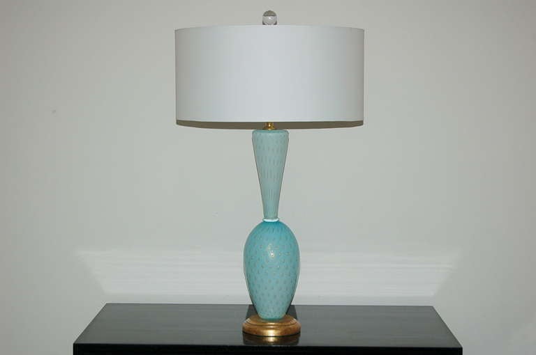 Matched pair of Vintage Murano table lamps blown in the 1950s. The glass is a soft and rich ROBIN'S EGG BLUE with large controlled bubbles surrounded by GOLD. The pattern and detail are incredible!

The lamps stand 25 inches to the top of the