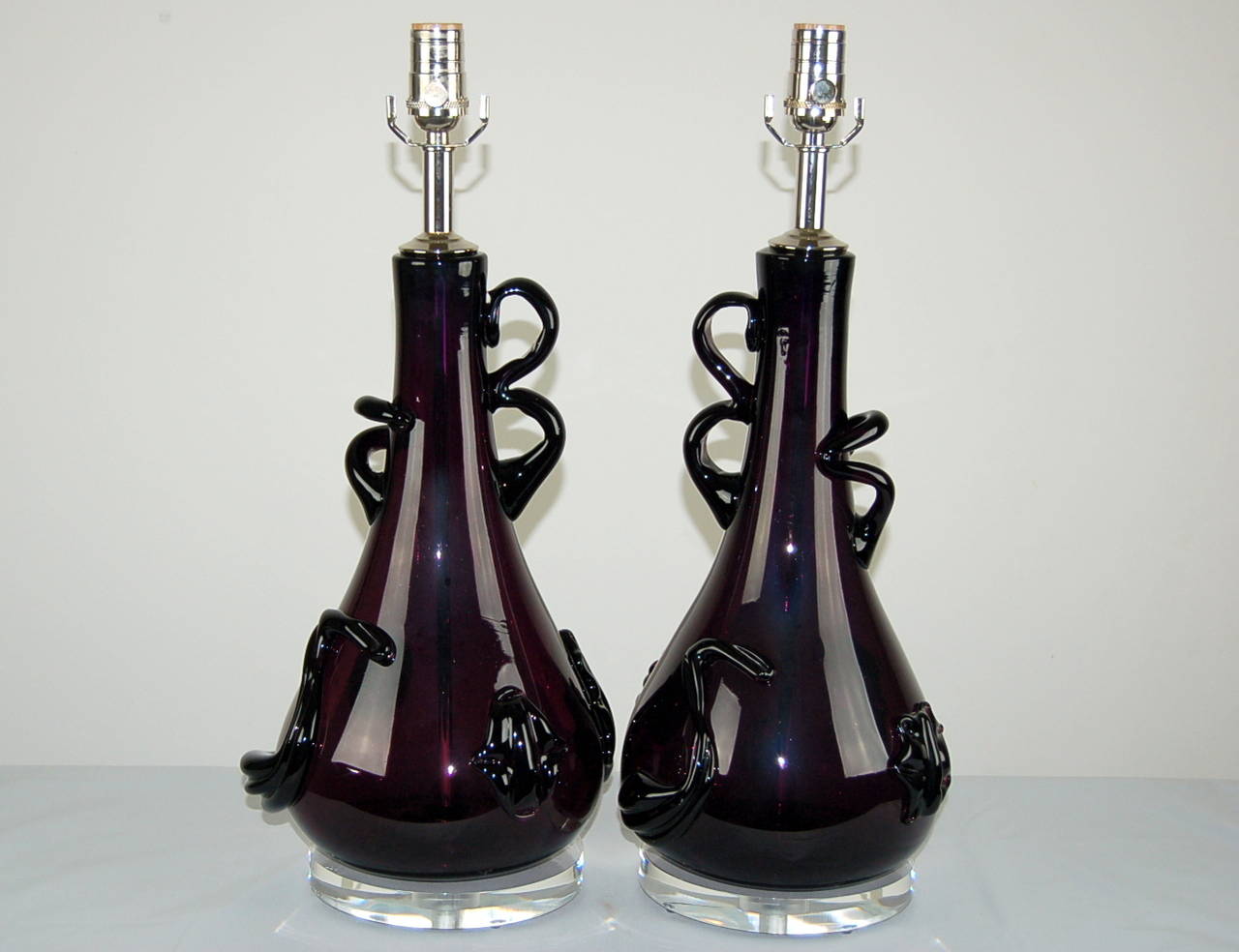 One of a kind!  A matched pair of Medusa-like, abstract Murano lamps in PURPLE. Large badge-like prunts and flailing glass arms - you won't see these lamps on anyone else's table!

The lamps are 22 inches from table top to socket top. As shown,