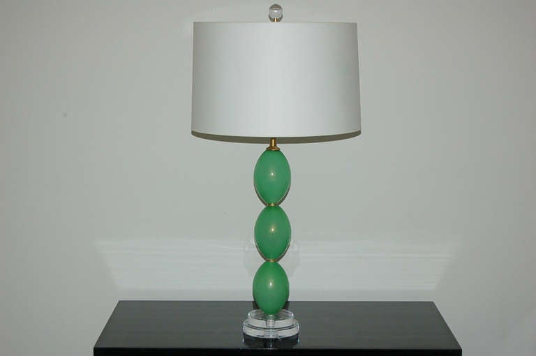 Exquisite pair of vintage lamps made of stacked Murano glass eggs in a soft LIME MINT, loaded with 24kt gold dust.  These have been completely rebuilt with brushed solid brass hardware and mounted on two tiers of Lucite.

These lamps measure 27
