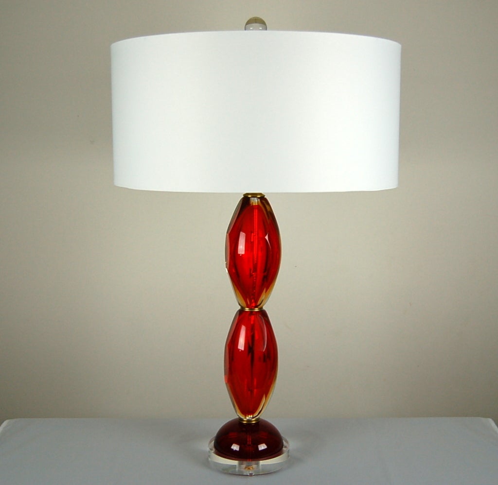 A heavy layer of thick, clear glass surrounds the LIPSTICK RED Murano core. GOLDEN highlights appear in various areas, as if by magic.  Mounted on a half-round of vintage Murano glass, atop Lucite. 

They measure 24 inches from tabletop to socket