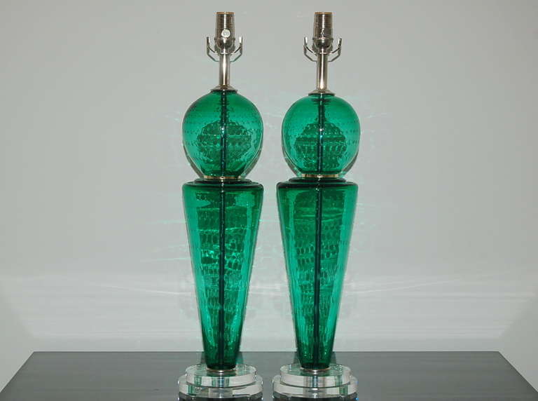 A whimsical pair of two-piece Murano lamps, separated by shiny nickel discs, in JADE GREEN.  The clarity of the glass and controlled bubbles create a fascinating optical treat - enlarge our photos and see the magic!

They measure 27 inches from