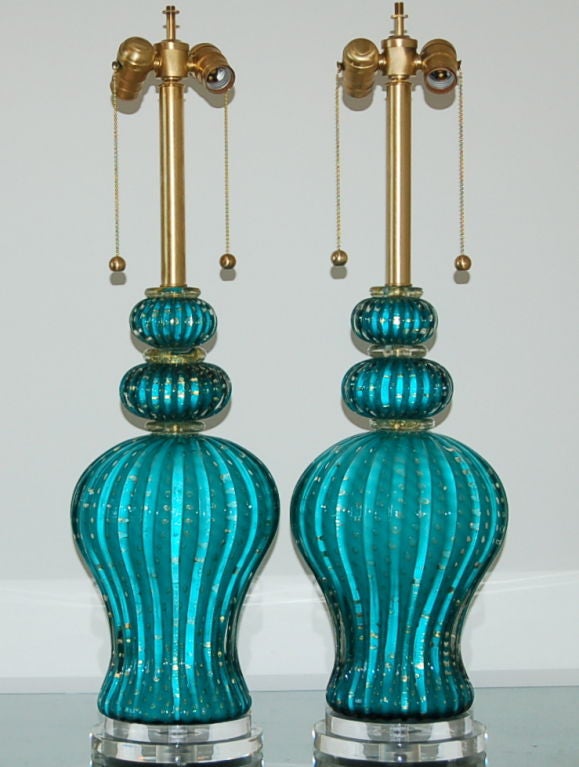 Barovier & Toso at its very best - three pieces of gorgeous hand blown glass with curves in all the right places.  This is a one of a kind pair in a color I can't quite describe.  Not aqua, not teal.  More of a blue green blue.  Lots of controlled
