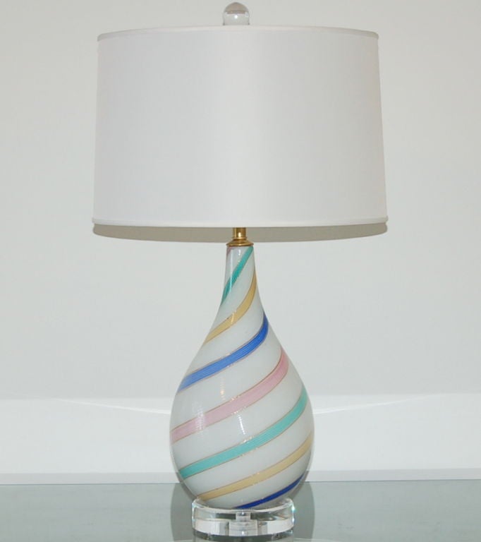 A gorgeous accent lamp with a whimsical twist - unique and beautiful RAINBOW PASTEL design by Dino Martens for Aurileano Toso in the 1950's. The simple filigrana swirls are accentuated by a glimmering copper border.

The lamp stands 22 inches from