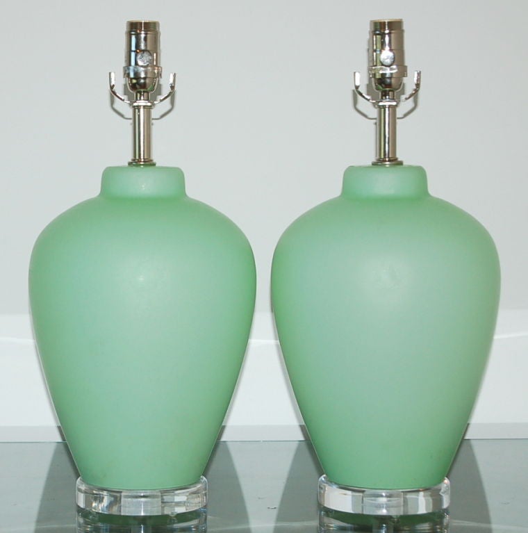 Perfectly proportioned for bedside or vanity, these wonderful vintage Murano lamps are the green of an after dinner mint.  The glass itself is opaque with a satin finish.  Based simply on a lucite wafer and available with nickel hardware for a