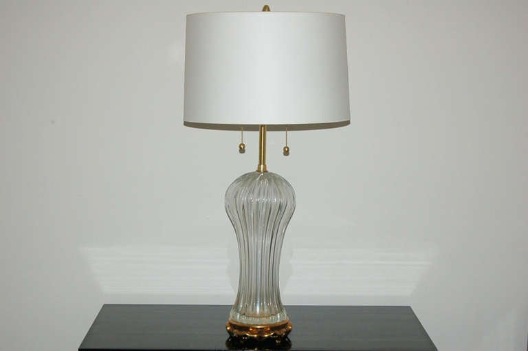 Classic Murano glass lamps by The Marbro Lamp Company on brass toned wreath base.  Glass is CRYSTAL CLEAR, thick, and vertically ribbed. 

They measure 34 inches to the double cluster socket.  As shown, the top of shade is 36 inches high. 