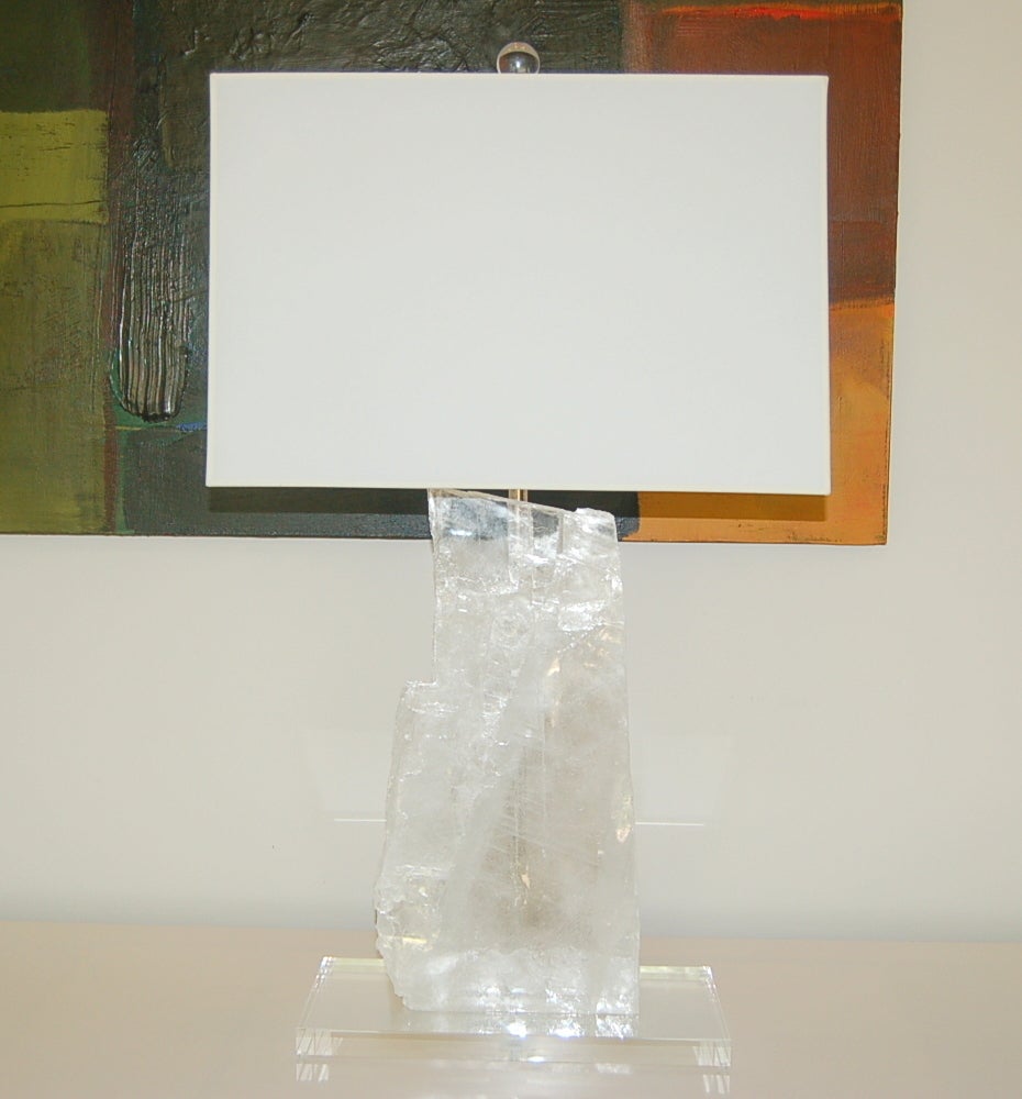 Stunning sheets of selenite mounted on beveled Lucite plinths. Downward facing double-lights shine upon each slice, providing an ethereal glow when lit. 

The lamps are 31 inches to the socket top, (the slabs are approximately 18 inches high and
