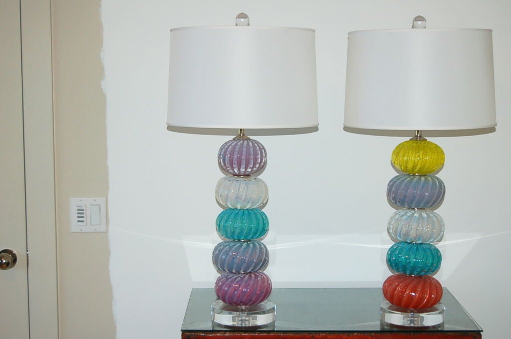 Several Murano importers offered the stacked ball and font lamp design in the mid 20th century.  These were created with both mixed color and technique, including pulegoso and controlled bubbles. Each piece was hand blown by a different artisan