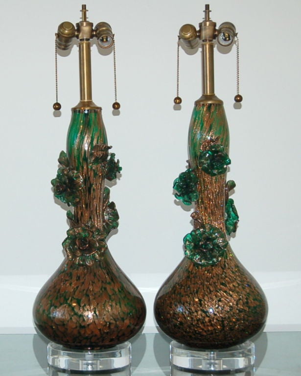 For a traditional look with a kick, may we suggest these Murano lamps by Marbro. They are a deep emerald green with lots of copper dust inclusion. Hand applied Murano glass flowers wind their way up and around the neck of the glass. The detail of