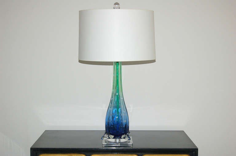 These finned vintage Murano lamps by Seguso are stylish and rare. The color begins as an intense COBALT BLUE and fades to EMERALD GREEN with large, controlled bubbles. Mounted on a double tier of Lucite. 

These lamp measure 25 1/2