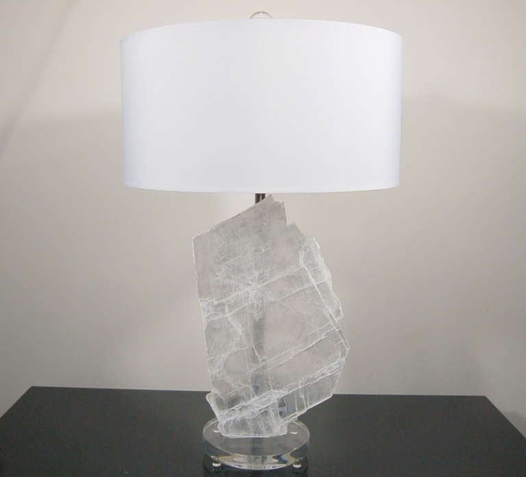 Panes of textured selenite, mounted on Lucite discs.  Downward facing double-lights shine upon each slice, providing an ethereal glow when lit. 

The lamps are 23 inches to the socket top and 10 inches wide. As shown, the top of shade is 26 inches