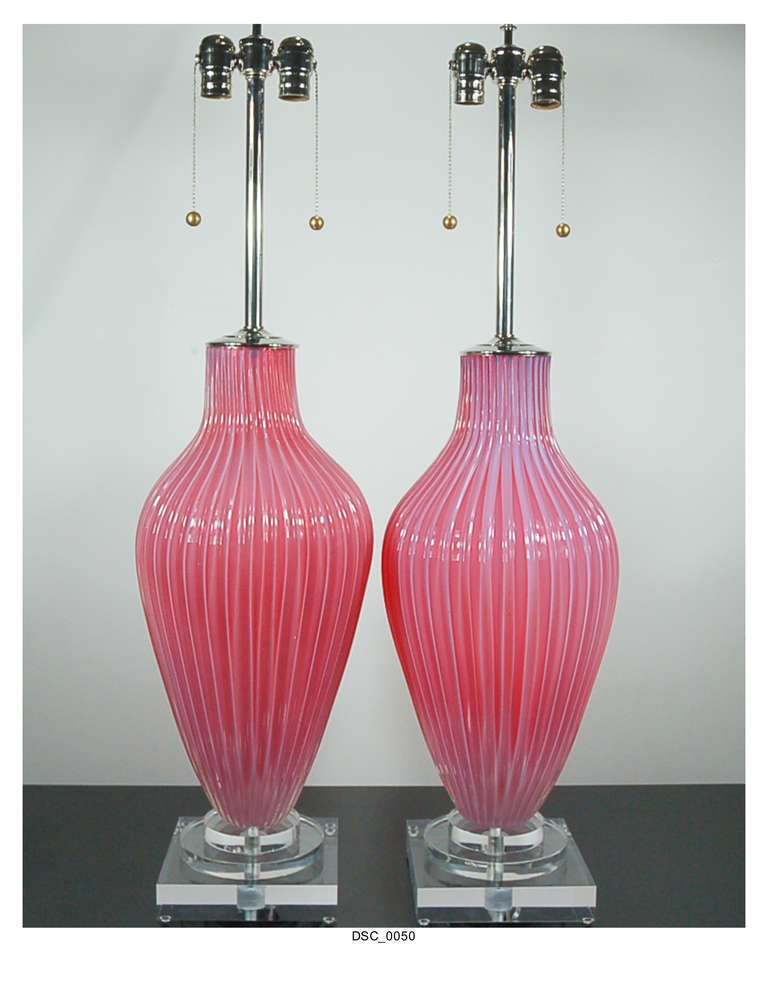 Exquisite Murano opaline lamps in raspberry sherbet by The Marbro Lamp Company. An enormous pop of candy color that glows in natural light, courtesy of the opaline. Just two reason why Marbro lamps remain cherished to this day. 

They stand 37