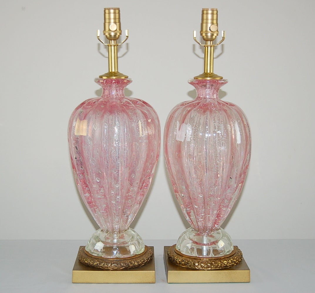 Matched pair of vintage Murano table lamps in COTTON CANDY PINK, heavily sprinkled with Silver flecks. A great traditional look with that lovely pop of candy color. 

They stand 22 inches from tabletop to socket top. As shown, the top of shade is 28