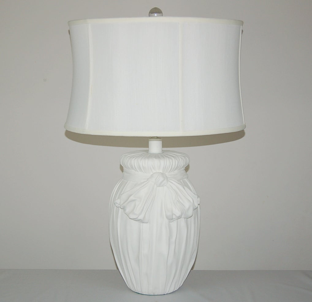 Matched pair of plaster lamps, each with an enormous bow, a la John Dickinson. So elegant in their simplicity, with more than a touch of whimsy. 

They stand 20 inches from tabletop to socket top. As shown, the top of shade is 27 inches high.