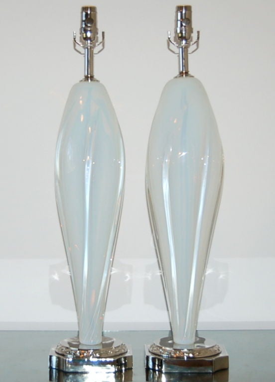 Beautiful Archimede Seguso Murano lamps in white opaline glass with swirling vertical ribs of clear glass. The lead blown into the glass gives it a magical quality and the glass takes on a very subtle light blue hue. So elegant! 

The lamps are 27