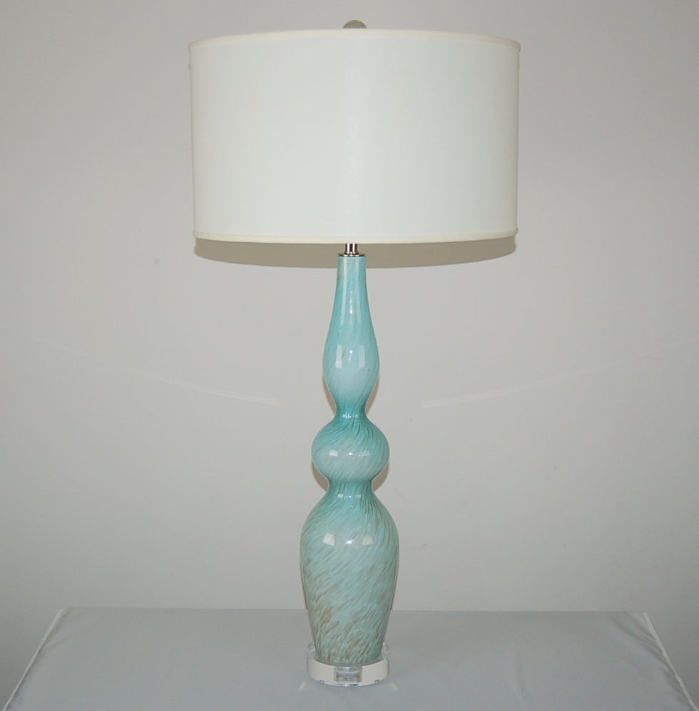 Curvaceous pair of SKY BLUE Murano table lamps heavily peppered with BRONZE SWIRLS, a la Fratelli Toso. A very sexy, stylish pair of sky scrapers!

They stand 30 inches from tabletop to socket top. As shown, the top of shade is 35 inches high.