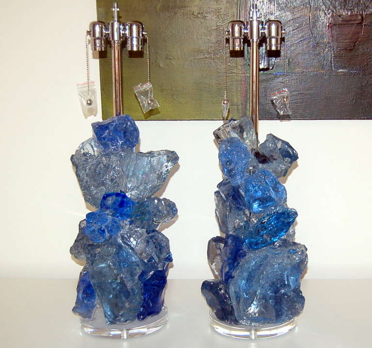 These exquisite cluster lamps in BLUE CRYSTAL are made of 100% recycled glass. Gorgeous eco-friendly art pieces that really light up a room. They are designed by Swank Lighting. Wonderful texture in each chunky glass piece. 

The lamps measure 27