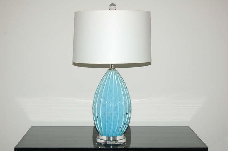 Our last pair of matched vintage Murano lamps by Alfredo Barbini in ROBIN EGG BLUE with controlled bubbles, a Barbini trademark.   Mounted on double platter Lucite bases.

The lamps measure 21 inches from tabletop to socket top. As shown, the top