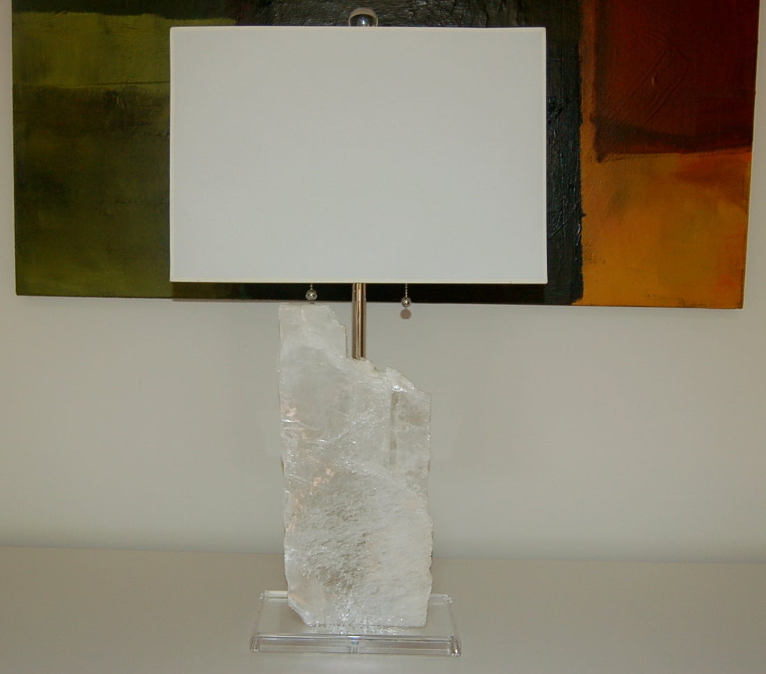Stunning sheets of Selenite mounted on beveled Lucite plinths. Downward facing double-lights shine upon each slice, providing an ethereal glow when lit. 

They stand 25 inches from tabletop to socket top. The sheets themselves are approximately 17